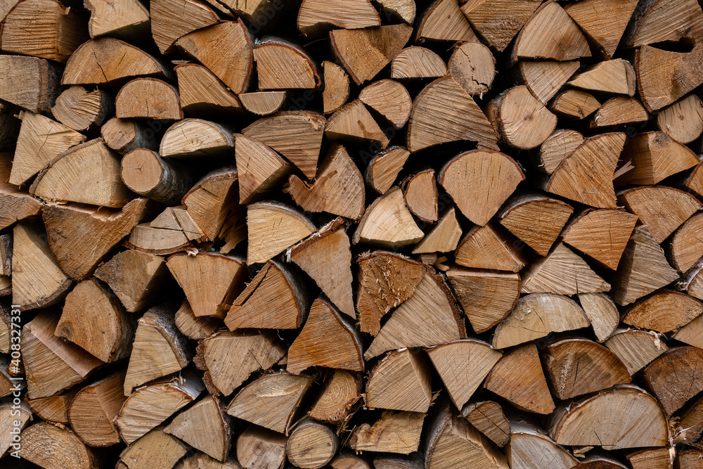 foreground of a pile of split firewood with ends of firewood of different shapes foreground of a pile of split firewood with ends of firewood of different shapes