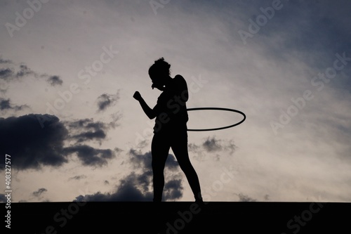  woman playing with dance hoop in the afternoon