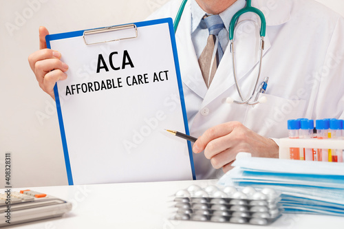 Doctor holds paper with ACA Affordable Care Act photo