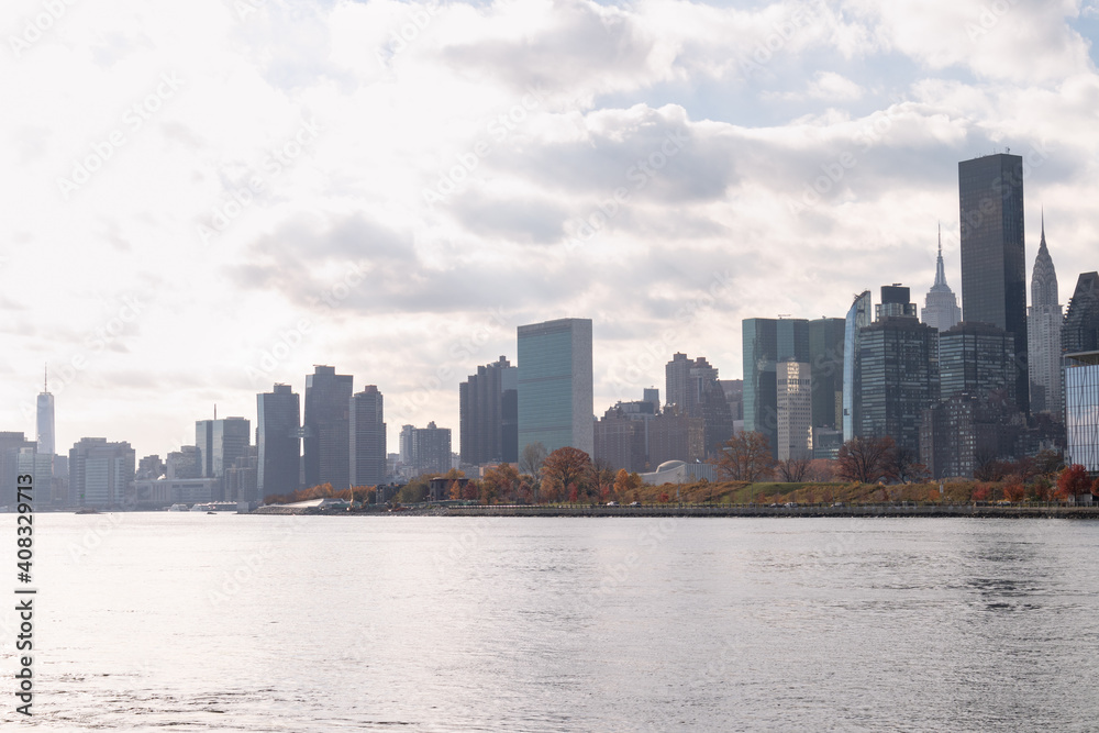 Roosevelt Island and Manhattan Skyline along the East River during Autumn with Colorful Trees in New York City