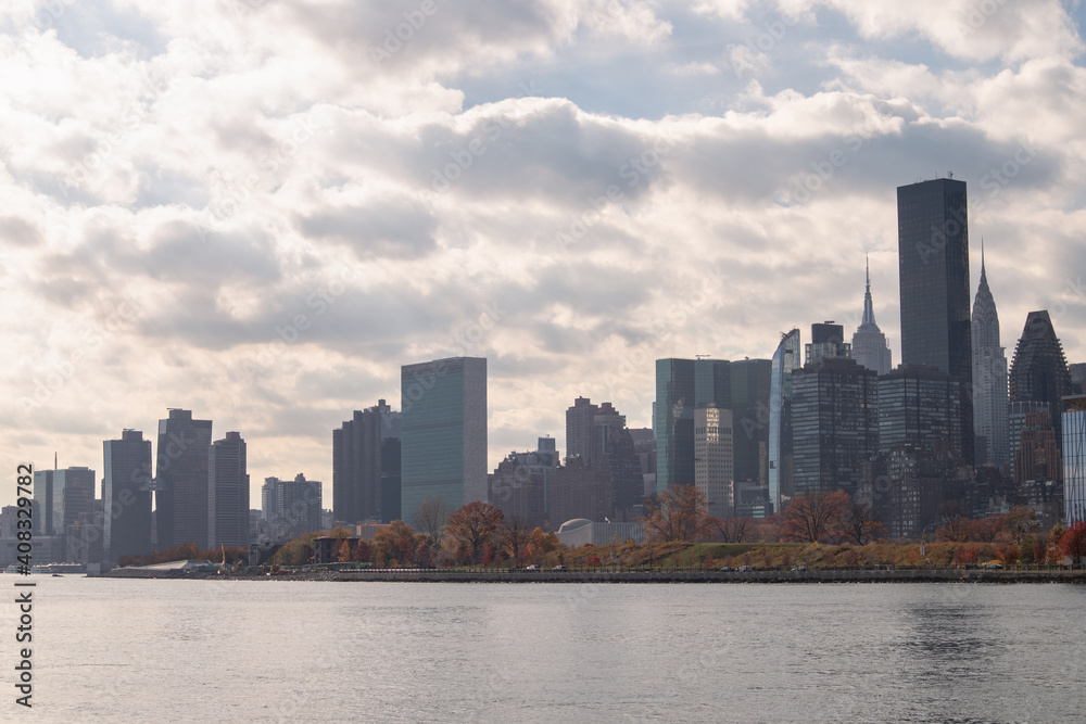 Roosevelt Island and Manhattan Skyline along the East River during Autumn with Colorful Trees in New York City
