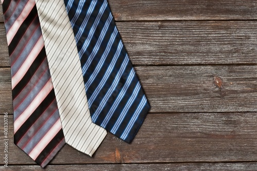 set of stylish men's accessories. Various ties on a wooden background. Father's Day concept. greeting card. Copy space, flat lay.