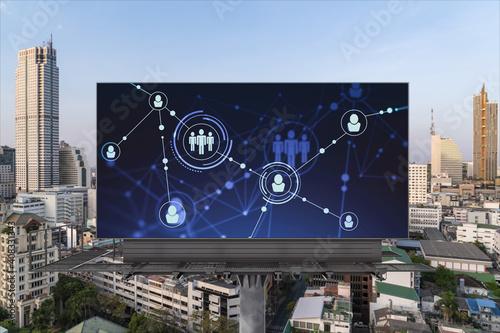 Glowing Social media icons on road billboard over panoramic city view of Bangkok, Southeast Asia. The concept of networking and establishing new connections between people and businesses.