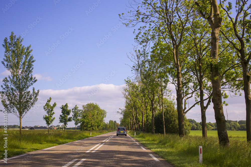 Car driving on an empty road