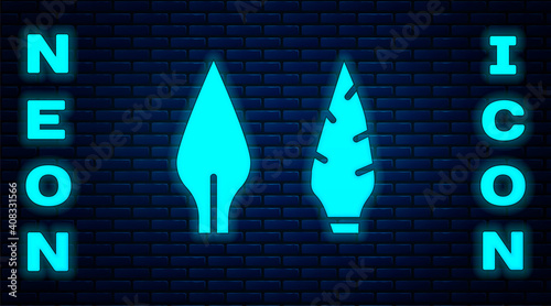 Glowing neon Stone age arrow head icon isolated on brick wall background. Medieval weapon. Vector.