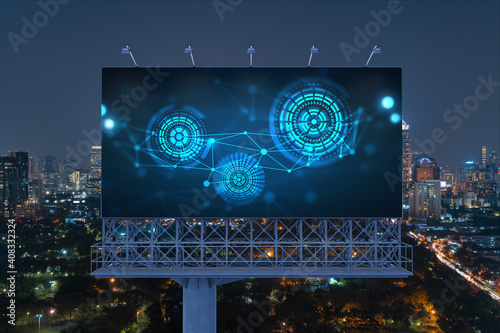 Information flow hologram on road billboard, night panorama city view of Bangkok. The largest technological center in Southeast Asia. The concept of programming science.