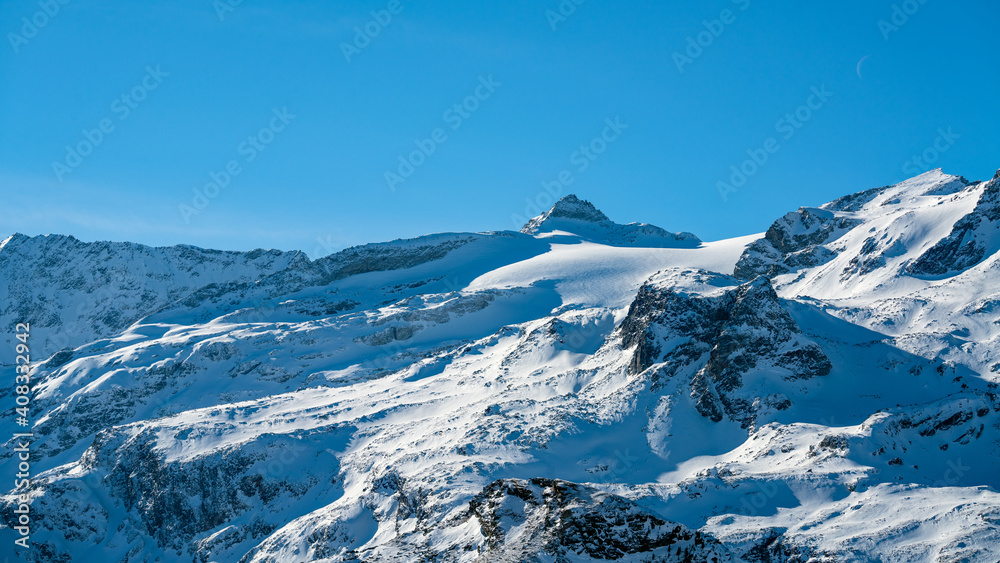 beautiful alpine landscape with fresh snow on a sunny day
