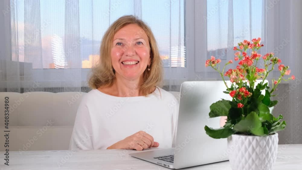 smiling elegant woman with a video call on a laptop. Communication concept. smiling elegant woman with a video call on a laptop. Communication concept.