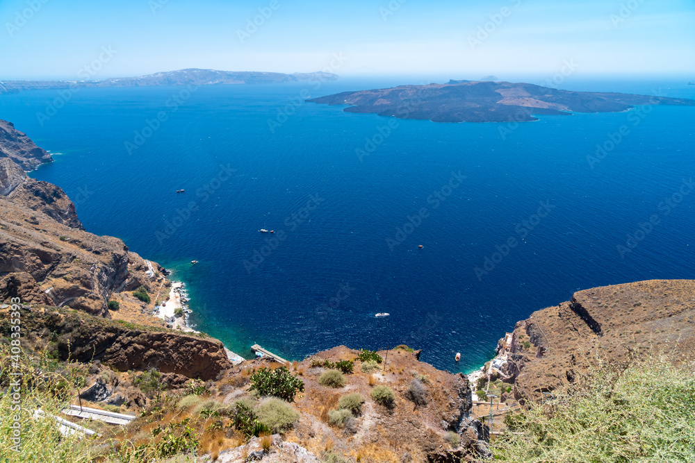 Fototapeta premium Balconies and roof tops in the village of Oia, Santorini. Architecture and landscape of Greece. Amazing panoramic view.