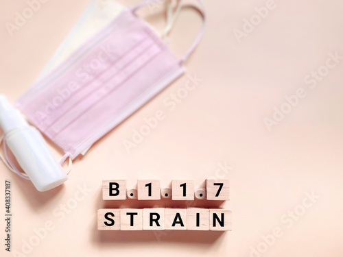 Healthcare and social issue concept - B.1.1.7 STRAIN text on wooden blocks background. Stock photo. photo