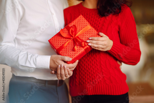 Exchange of gifts.  Young couple in love offering gift to each other for valentine day or birthday. Romantic day. Winter holidays. © maxbelchenko