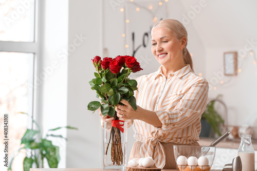 Mature woman with bouquet o...