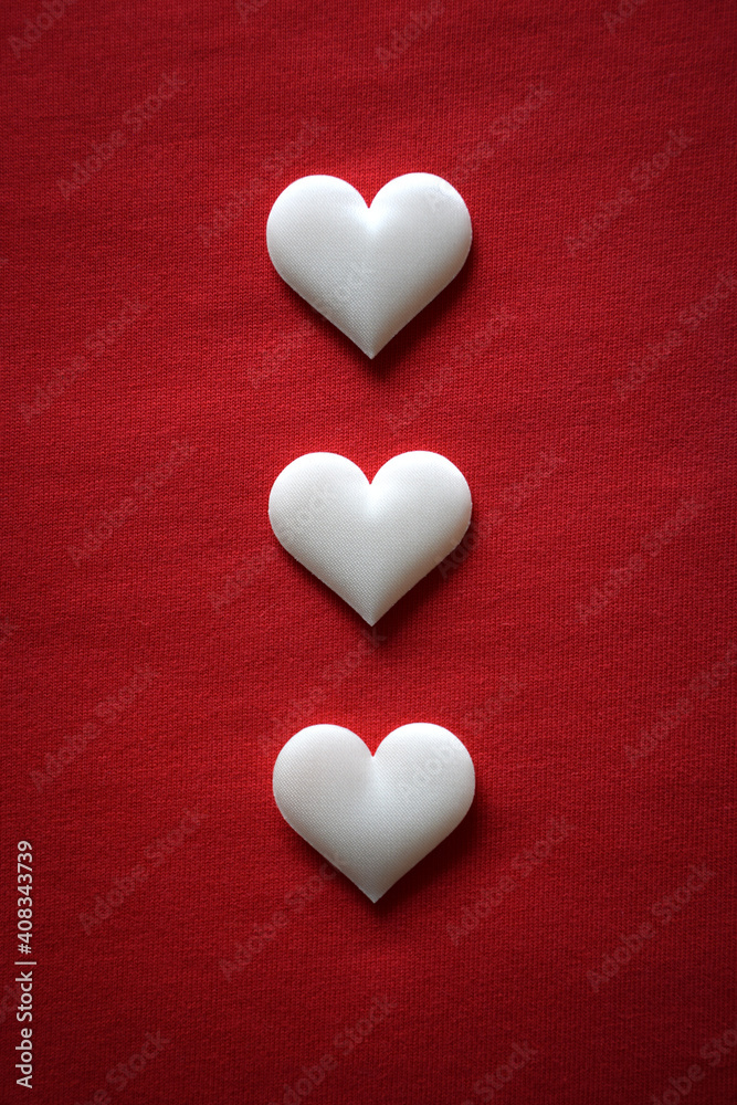 Three white hearts on a red background Three white hearts on a red background