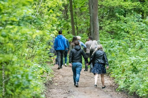 Pomiechówek, Poland - May 24, 2020: Spring in the forest. People walking in the park. A trip through the woods among lush green trees.