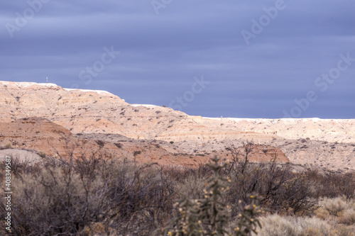 Blue grey sky behind rocky mesa plateau in the New Mexico desert