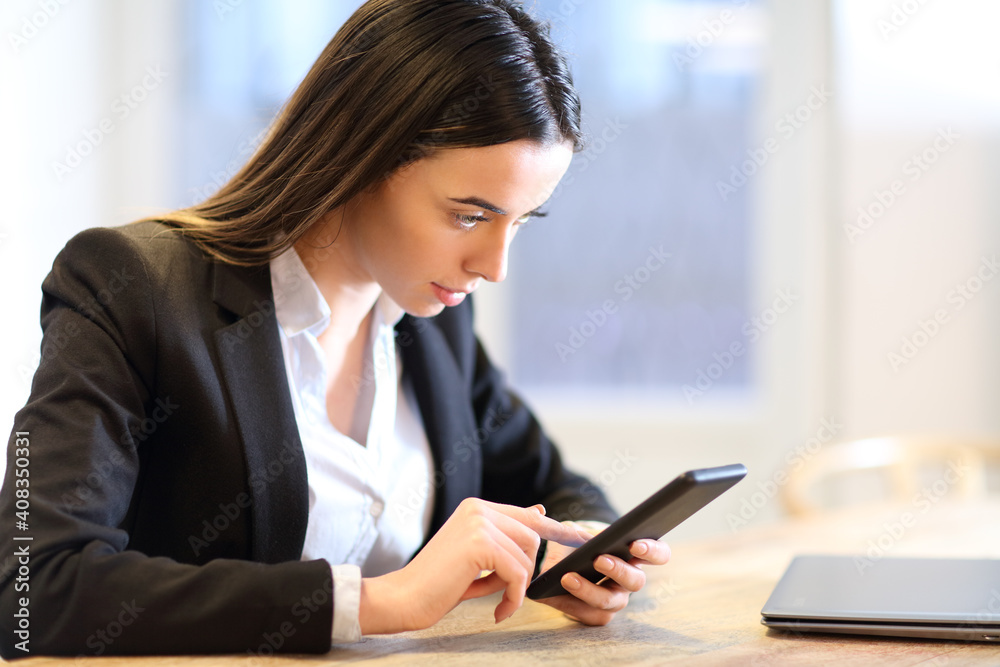 Business woman checking phone working at office Business woman checking phone working at office