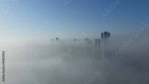 Drone view of Fog over Sharjah, Sharjah Khalid Lake covered in the winter morning fog, United Arab Emirates, 4K Drone Footage photo