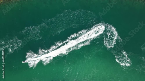 Top view of jet-skiing in blue-green crystal clear water of Dubai's Mamzar beach, Arabian Sea, top tourist attraction, UAE, 4k Footage photo