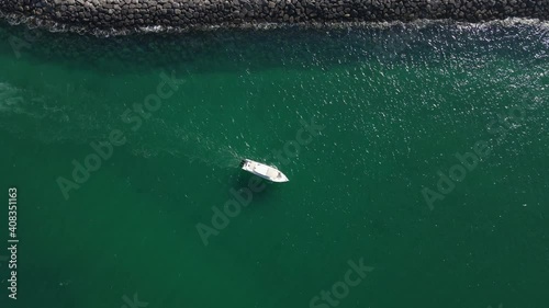 Aerial View of Small Ship Floats on Sea Surface of Dubai's Mamzar beach, Arabian Sea, top tourist attraction, UAE, 4k Footage photo