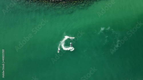 Top view of jet-skiing in coast blue-green crystal clear water of Dubai's Mamzar beach, Arabian Sea, top tourist attraction, 4k Footage photo
