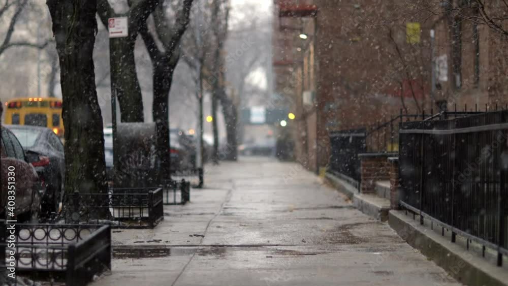 Snow tumbling down on cold winter Brooklyn street, in New York - Long medium shot Snow tumbling down on cold winter Brooklyn street, in New York - Long medium shot