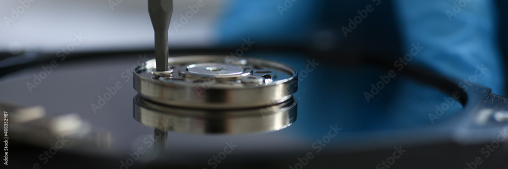 Close up of screw being screwed into metal part with a screwdriver. Repair concept. Mechanic or engineer instruments Close up of screw being screwed into metal part with a screwdriver. Repair concept. Mechanic or engineer instruments