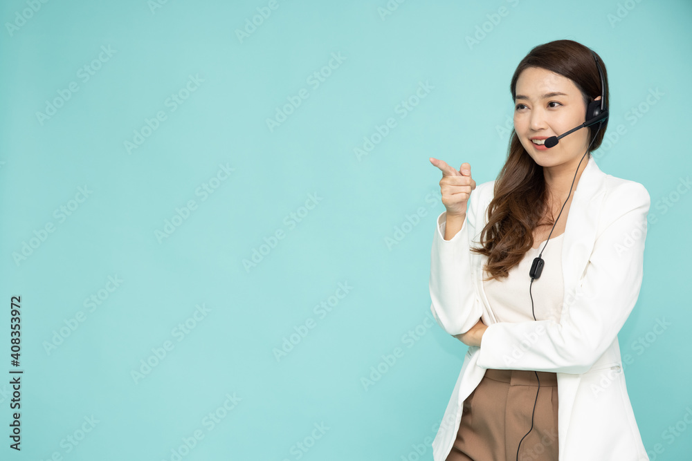 Portrait of happy smiling asian woman customer support phone operator and pointing to empty copy space isolated on green background, Call center or Customer service concept Portrait of happy smiling asian woman customer support phone operator and pointing to empty copy space isolated on green background, Call center or Customer service concept