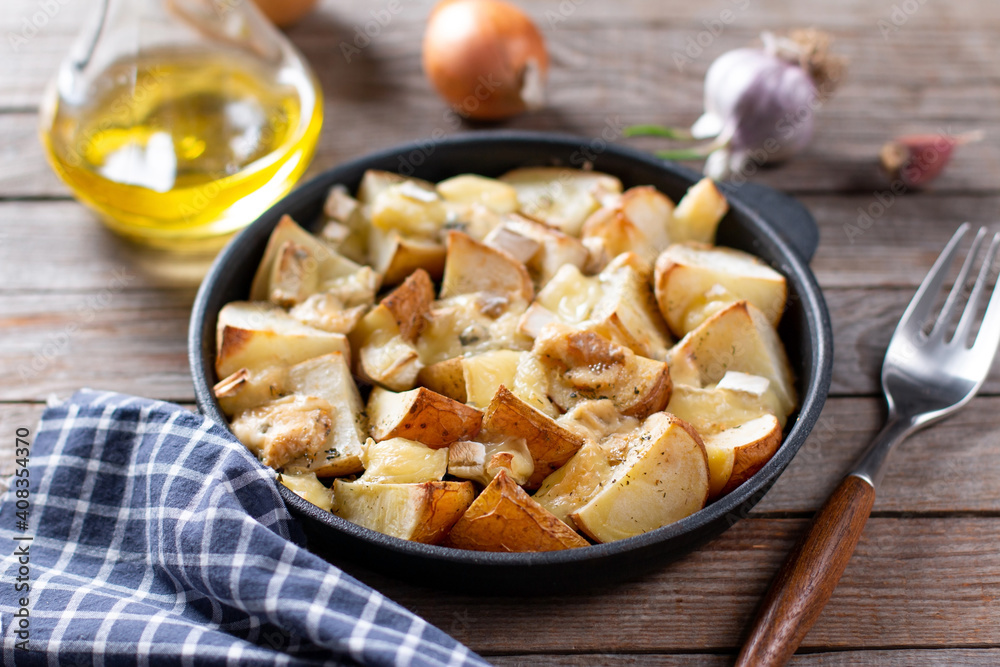 Baked potatoes with cheese in a pan. Selective focus Baked potatoes with cheese in a pan. Selective focus