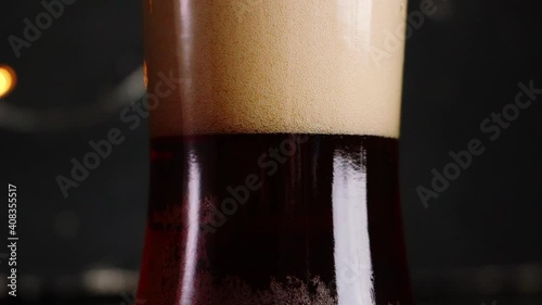 Pooring Red Ale Beer With A Dark Background