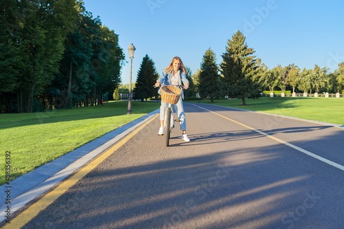 Wallpaper Mural Young woman on bike riding on road in sunset park Torontodigital.ca