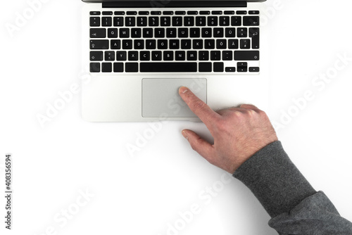 overhead view of person using touchpad or trackpad on laptop computer on white background photo
