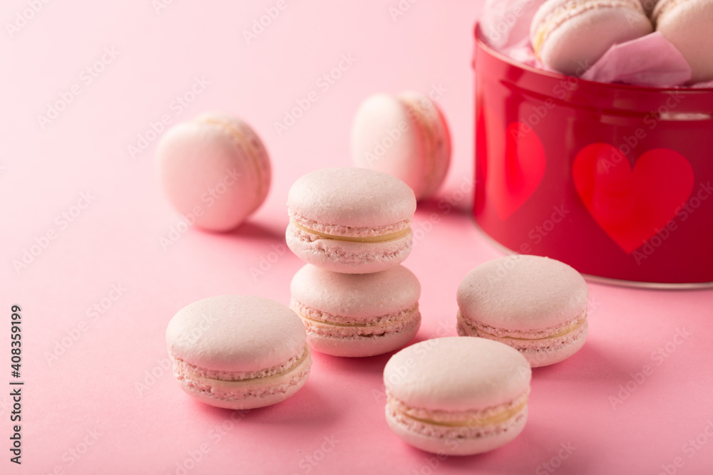 Rose macaroons present in red gift box on pink Rose macaroons present in red gift box on pink