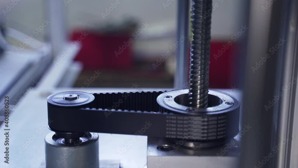 Reasonable belt on machine revolves around shaft. Iron gears and toothed shaft rotate in machine Reasonable belt on machine revolves around shaft. Iron gears and toothed shaft rotate in machine