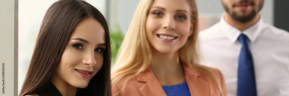 Smiling pretty lady holding digital tablet and standing near her employees. Business concept Smiling pretty lady holding digital tablet and standing near her employees. Business concept