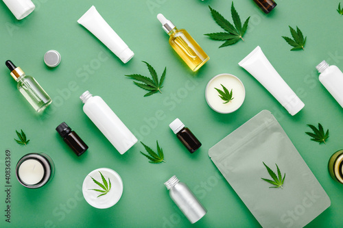 Hemp cbd oil serum in glass dropper bottle with cannabis leaves, Moisturizing cream, Serum, lotion, essential oil. Cannabis leaf with skincare cosmetic product Flat lay pattern on green background