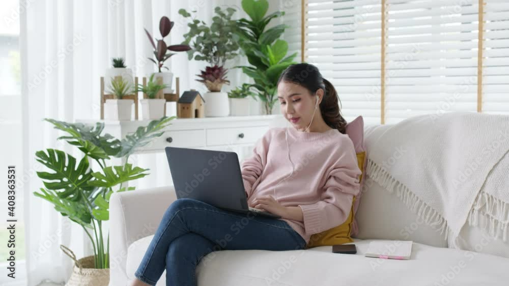 Young attractive beautiful asia female relax sit or lying down on sofa couch or floor in comfortable position at cozy home living room with green garden houseplant happy workplace work from home. Young attractive beautiful asia female relax sit or lying down on sofa couch or floor in comfortable position at cozy home living room with green garden houseplant happy workplace work from home.