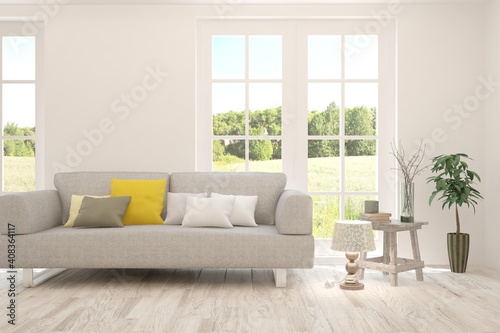 White living room with sofa and summer landscape in window. Scandinavian interior design. 3D illustration