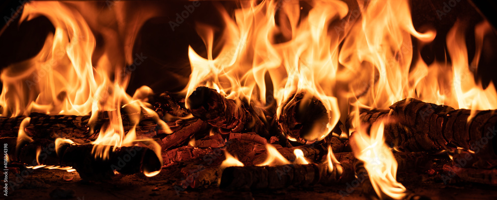 Fototapeta premium Burning wood in a wood fired pizza oven