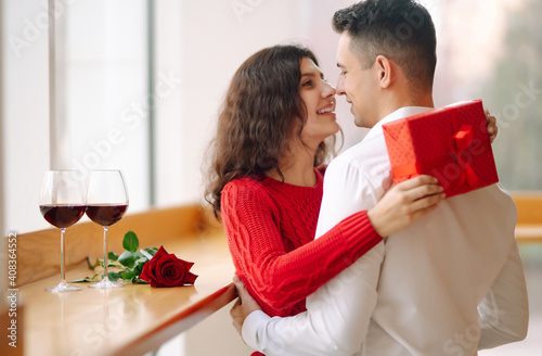 Wallpaper Mural Young couple with gift box hugging and celebrating Valentine's Day. Relationship, holiday,  surprise and love concept. Torontodigital.ca