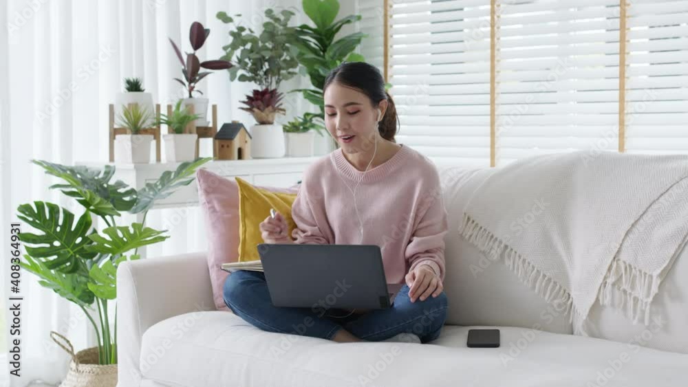 Young attractive beautiful asia female relax sit or lying down on sofa couch or floor in comfortable position at cozy home living room with green garden houseplant happy workplace work from home. Young attractive beautiful asia female relax sit or lying down on sofa couch or floor in comfortable position at cozy home living room with green garden houseplant happy workplace work from home.