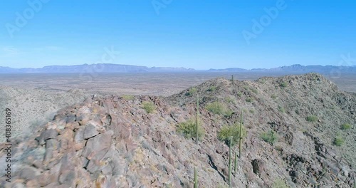 Flying over desert peak with saguaro cactus drone aerial shot