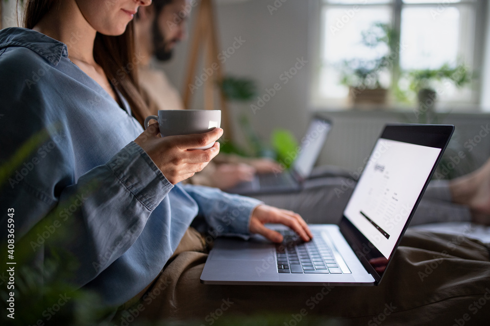 Unrecognizable couple using laptops on bed indoors, home office concept. Unrecognizable couple using laptops on bed indoors, home office concept.