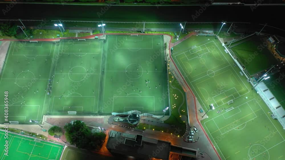night time illuminated hong kong city famous sport stadium complex topdown aerial panorama 4k 