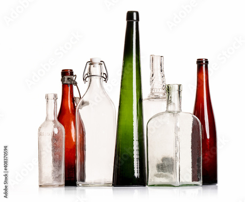 Various transparent and colored old antique alcohol bottles isolated studio shot