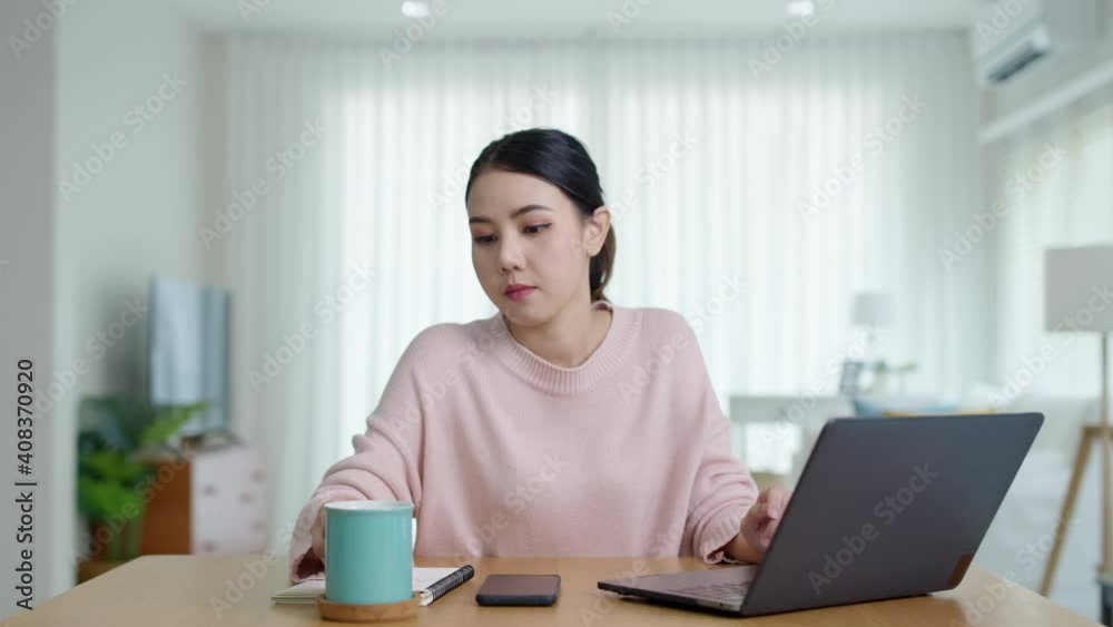 Young attractive beautiful asia happy female take coffee break rest relax from work computer notebook at home move out from table to refill drink. Lifestyle at home quarantine social distance concept. Young attractive beautiful asia happy female take coffee break rest relax from work computer notebook at home move out from table to refill drink. Lifestyle at home quarantine social distance concept.