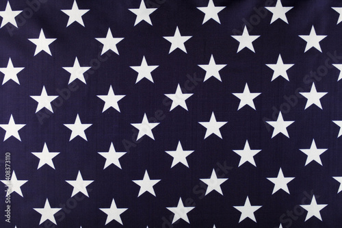 White stars on a blue background, USA flag close-up, background, top view.