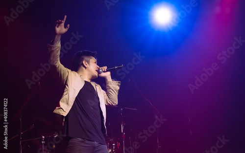 Asian male singer showing his performance on stage