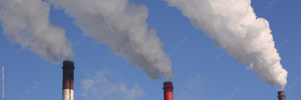 Cropped photo of high chimney pipes with white smoke from coal power plant. Production of electricity concept