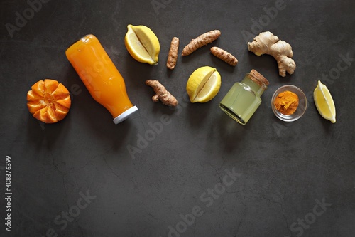 Pure vegan Immunity system booster. Ginger shot with citrus fruits juice and turmeric. Flat layot, copy space