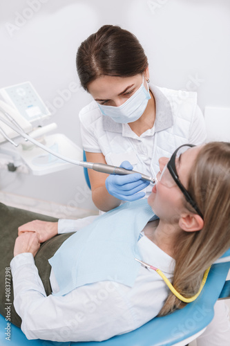 Vertical top view shot of a female dentist working with patient